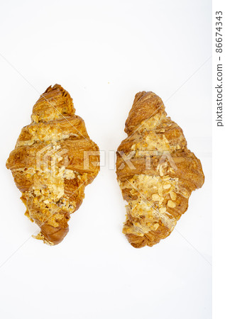 Fresh sweet croissants for breakfast on white. Studio Photo 86674343