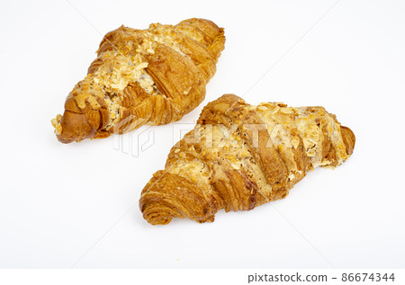 Fresh sweet croissants for breakfast on white. Studio Photo 86674344