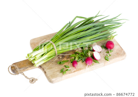 Fresh green onions, red radish on cutting board. Fresh green onions, red radish on cutting board. 86674772