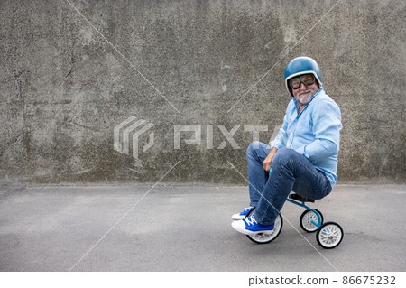 Funny businessman driving retro trike outdoor 86675232