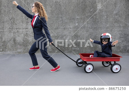 Happy woman and child going to work outdoor 86675250