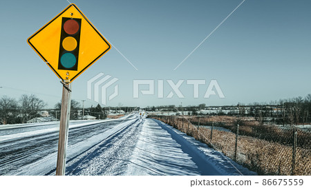 snow covered sidewalk with street sign and horizon 86675559