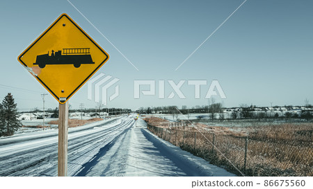 snow covered sidewalk with street sign and horizon 86675560