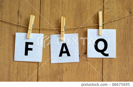FAQ frequently asked questions symbol. Concept words FAQ frequently asked questions on white papers on a beautiful wooden background. Business and FAQ frequently asked questions concept. 86675695