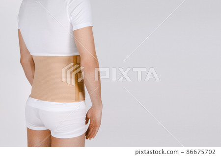 Orthopedic lumbar corset on the human body. Back brace, waist support belt for back. Posture Corrector For Back Clavicle Spine. Post-operative Hernia Pregnant and Postnatal Lumbar brace after surgery. Orthopedic lumbar corset on the human body. Back brace, waist support belt for back. Posture Corrector For Back Clavicle Spine. Post-operative Hernia Pregnant and Postnatal Lumbar brace after surgery. 86675702