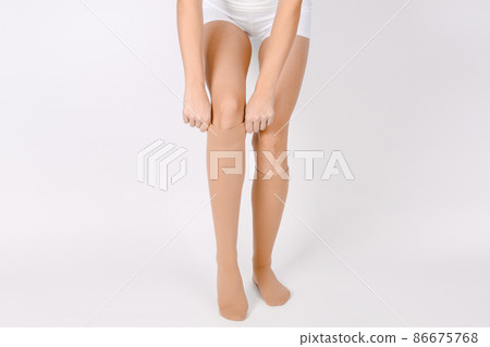 Medical Compression Stockings for varicose veins and venouse therapy. Compression Hosiery. Sock for sports isolated on white background. Beige color socks mock up for advertising, branding, design. Medical Compression Stockings for varicose veins and venouse therapy. Compression Hosiery. Sock for sports isolated on white background. Beige color socks mock up for advertising, branding, design. 86675768
