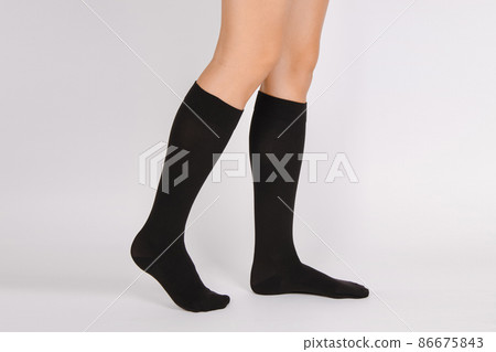 Medical Compression Stockings for varicose veins and venouse therapy. Compression Hosiery. Sock for sports isolated on white background. Black color socks mock up for advertising, branding, design. 86675843