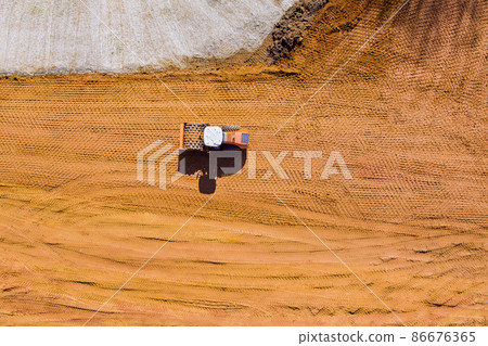 Grader is working on new building construction site with preparation of the land 86676365