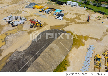Aerial view drainage sewage system pipes stacked in ground during plumbing with preparation of the land for the construction site 86676367