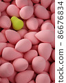 beauty background a bunch of pink gentle sponges and one contrast green conflict for makeup vertical orientation 86676834