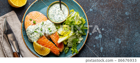 Healthy food meal cooked grilled salmon steaks with dill sauce and salad leafs on plate 86676933