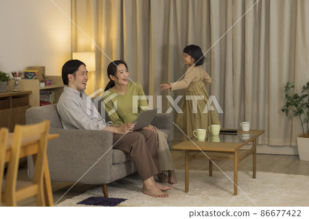 Family spending in the living room at night 86677422