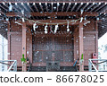 A shrine nestled in a snowstorm Snow and shrine worship hall 86678025