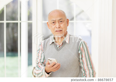 Senior men using smartphones Senior men using smartphones 86678657