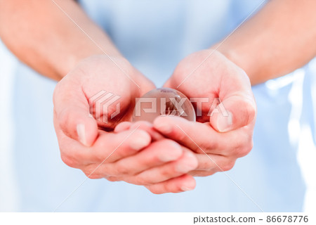 Parts cut: A man's hand holding an earth crystal 86678776