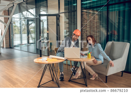 Man showing sketch to attentive woman Man showing sketch to attentive woman 86679210