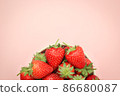 Half top view of strawberries in a cup with copy space. 86680087