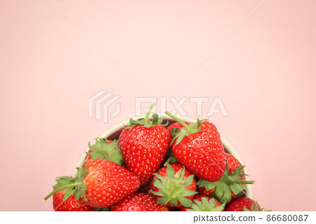 Half top view of strawberries in a cup with copy space. 86680087