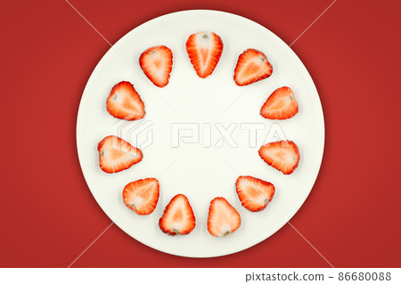 Top view of half strawberry in a plate on isolated red background. Top view of half strawberry in a plate on isolated red background. 86680088