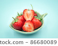 Top view of red strawberry in a small cup on isolated pastel background. 86680089