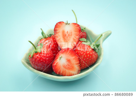 Top view of red strawberry in a small cup on isolated pastel background. 86680089