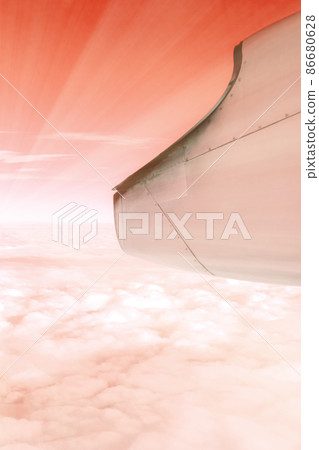 A wonderful view from the window of an airplane: red-orange and light like the setting sun A wonderful view from the window of an airplane: red-orange and light like the setting sun 86680628