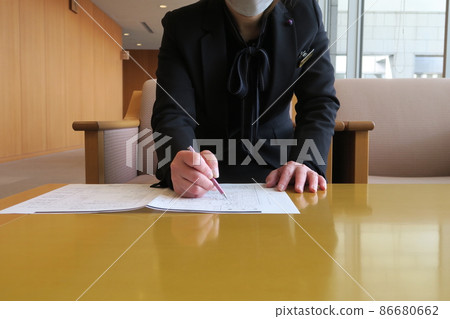Ceremony lady checking documents Ceremony lady checking documents 86680662