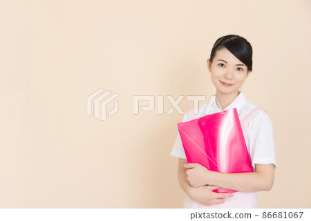 Woman in pink apron with file 86681067