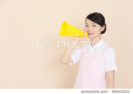 Female in pink apron with megaphone Female in pink apron with megaphone 86681081