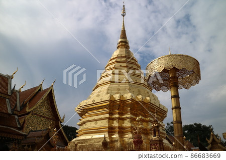 Blue sky and white clouds. Temples of Southeast Asian architecture with golden spires 86683669