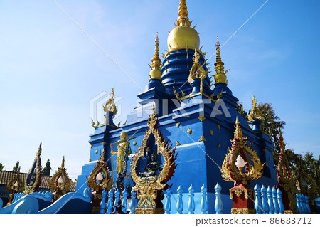 Blue building decorated with gilded gold at Rong Suea Ten Temple, a famous attraction in Chiang Rai, Thailand 86683712