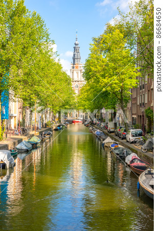 Amsterdam Canal with Boats on a Sunny Day 86684650