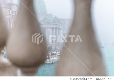 View through bridge fence on boats and old building View through bridge fence on boats and old building 86685962