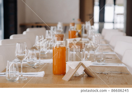 Empty dishes and cutlery on the table in the restaurant before dinner Empty dishes and cutlery on the table in the restaurant before dinner 86686245
