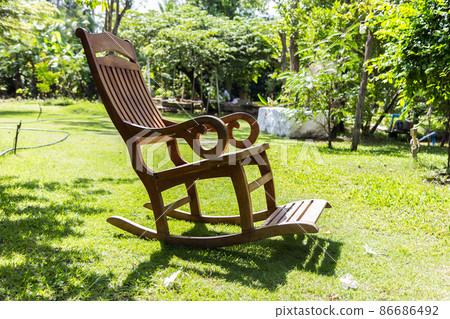 Empty rocking chair over grass 86686492