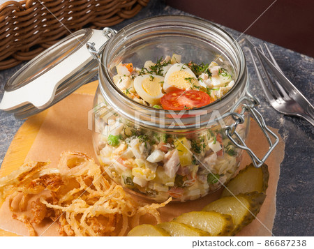 classic Olivier salad in a jar. Unusual serving in a restaurant classic Olivier salad in a jar. Unusual serving in a restaurant 86687238