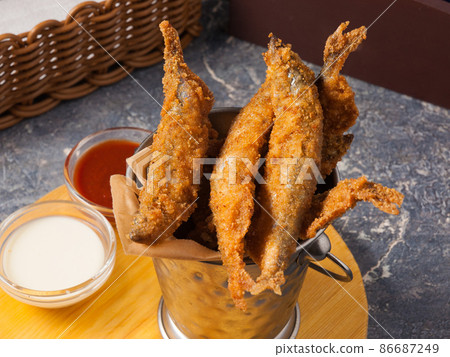 deep-fried crispy fish with tomato and garlic sauce. Concept deep-fried crispy fish with tomato and garlic sauce. Concept 86687249