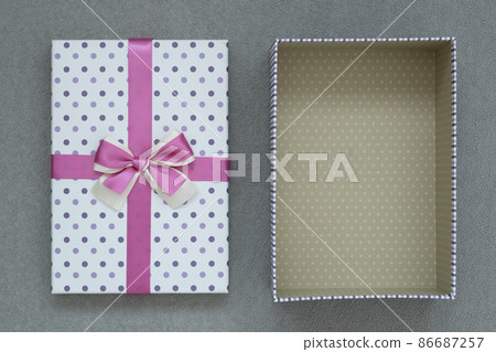 view from above. Open gift box on gray suede background. Next to it is the lid of the box view from above. Open gift box on gray suede background. Next to it is the lid of the box 86687257