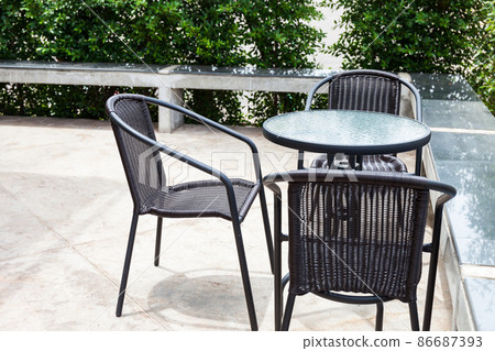 Striped table and wicker armchair Striped table and wicker armchair 86687393
