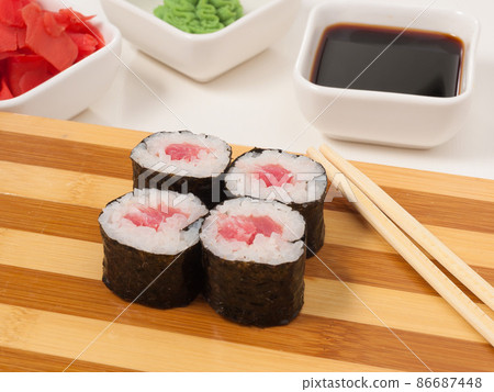 sushi roll with tuna in nori seaweed on a wooden Board 86687448