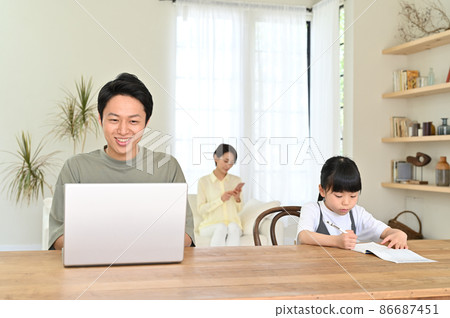 Girl studying next to her father during telework Girl studying next to her father during telework 86687451