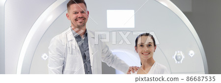 Smiling male doctor and female patient in MRI room closeup Smiling male doctor and female patient in MRI room closeup 86687535