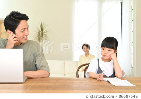 Girl studying next to her father during telework Girl studying next to her father during telework 86687549