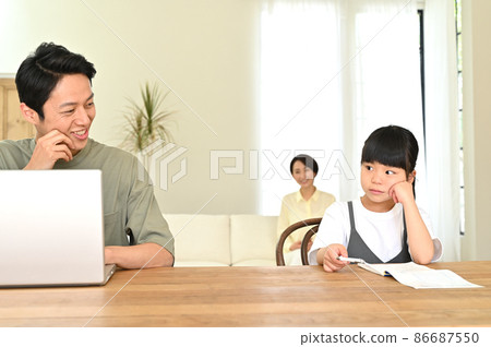 Girl studying next to her father during telework Girl studying next to her father during telework 86687550