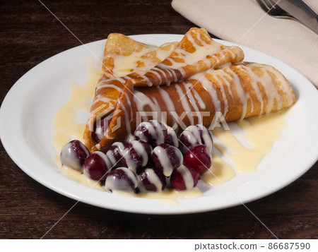 sweet pancake with cherries and condensed milk sweet pancake with cherries and condensed milk 86687590