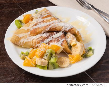 pancake with fruit orange banana kiwi and condensed milk pancake with fruit orange banana kiwi and condensed milk 86687599