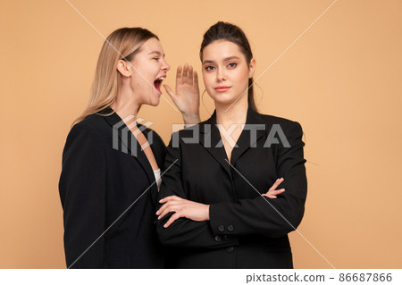 Boss yelling at employee. Colleague screaming on worker. Bulling on work. One woman shouting another woman standing isolated color background Boss yelling at employee. Colleague screaming on worker. Bulling on work. One woman shouting another woman standing isolated color background 86687866