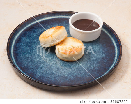 Cottage cheese pancakes with a chocolate topping. Concept Cottage cheese pancakes with a chocolate topping. Concept 86687891