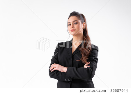 Young business woman arms crossed in black jacket standing studio isolated on white background. Young business woman arms crossed in black jacket standing studio isolated on white background. 86687944