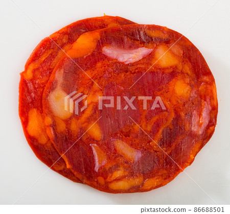 Sliced chorizo sausage on white background, macro Sliced chorizo sausage on white background, macro 86688501